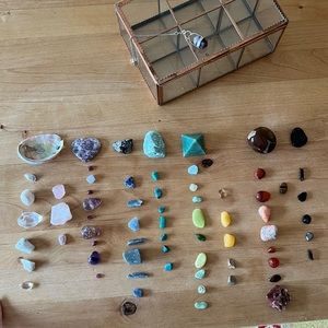 Crystal and stone collection with glass case and amethyst pendulum.